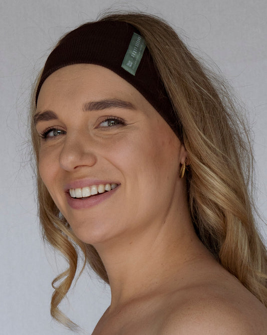 Woman wearing a brown headband with a white background